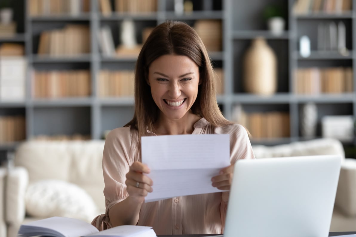 Excited young woman received bank loan approval notice.